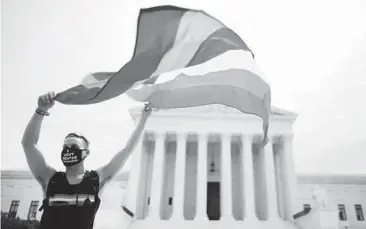  ?? CHIP SOMODEVILL­A/GETTY 2020 ?? A person in Washington, D.C., celebrates a Supreme Court ruling involving LGBTQ rights.