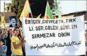  ?? DELIL SOULEIMAN/GETTY-AFP ?? Kurds during a protest on Friday hold a banner reading “No to Turkish strikes on the Syrian people.” The Turkish military intervened in the Syrian war in August this year.