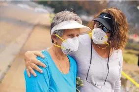  ?? MARCIO JOSE SANCHEZ/ASSOCIATED PRESS ?? Carol Smith, left, is comforted by her daughter, Suzie Scatena, after Smith saw her home Thursday in Redding, Calif., for the first time since it was burned by a wildfire.