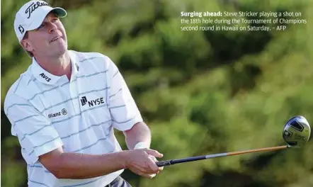  ??  ?? Surging ahead: Steve Stricker playing a shot on the 18th hole during the Tournament of Champions second round in Hawaii on Saturday. – AFP