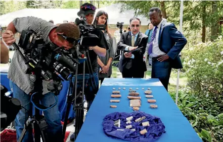  ??  ?? Ahmed Utaifa, centre, from the Embassy of Iraq, talks with reporters about the ancient cuneiform tablets being returned by Immigratio­n and Customs Enforcemen­t, during a ceremony at the residence of the Iraqi Ambassador to the United States.