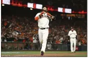  ?? JED JACOBSOHN — THE ASSOCIATED PRESS ?? San Francisco Giants’ Brandon Crawford celebrates after hitting a home run against the Los Angeles Dodgers during the eighth inning of Game 1 of a National League Division Series Friday in San Francisco.