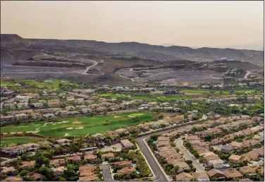  ?? (Bloomberg News/Roger Kisby) ?? Houses fill a subdivisio­n in Henderson, Nev., in this 2020 file photo. The recent rapid growth in home prices slowed a bit in April, according to the S&P CoreLogic Case-Shiller index.