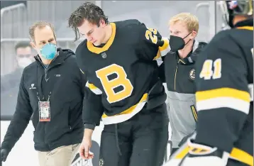  ?? AP ?? BOSTON BASH: The Bruins’ Brandon Carlo had to be helped off the ice Friday after the Capitals’ Tom Wilson smashed his head into the glass, which left him down for several minutes.