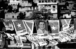 ?? MOISES CASTILLO/AP ?? Banners touting Honduran President Juan Orlando Hernandez hang Sunday in Honduras.