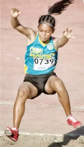  ?? SUNSTAR FOTO / ALEX BADAYOS ?? BEST LEAP. Kristine Tabarno adds a gold medal for Cebu Province after topping the triple jump.