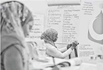  ?? Rahmeek Rasul ?? Women participat­e in a mental health training program for community members in Atlanta.