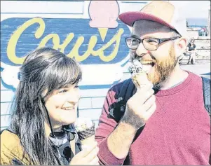  ?? MITCH MACDONALD/THE GUARDIAN ?? Ottawa residents David Bullock, right, and Jamie Schroder enjoy a cone of ice cream from the new COWS kiosk while visiting Halifax this summer. Bullock, who grew up in Ontario, was well aware of the popular P.E.I. brand even before he had ever visited...