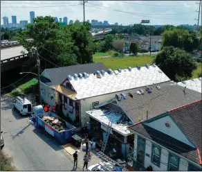  ?? ?? More than 100 roofs are being repaired in the 7th Ward, an area that was hammered by both Hurricane Katrina in 2005 and then Ida on the same day 16 years later.