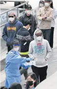  ?? AFP ?? A nurse guides visitors to take a Covid-19 test in Itaewon district.