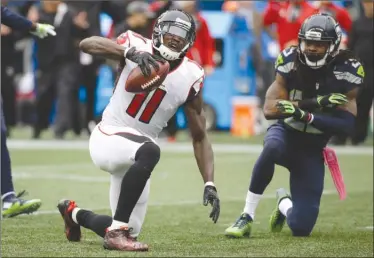  ?? The Associated Press ?? In this Oct. 16, 2016, file photo, Atlanta Falcons receiver Julio Jones (11) reacts after Seattle Seahawks cornerback Richard Sherman, right, broke up a pass intended for him during NFL action in Seattle. Jones and the Falcons get another shot at...