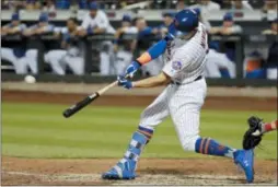  ?? FRANK FRANKLIN II — THE ASSOCIATED PRESS ?? The Mets’ Brandon Nimmo hits a game-winning three-run home run during the 10th inning of a baseball game against the Philadelph­ia Phillies on Wednesday in New York. The Mets won 3-0.