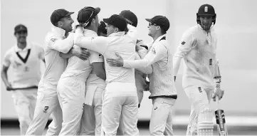  ??  ?? Australian players celebrate the dismissal of England’s Craig Overton (R) in the third Ashes cricket Test match between England and Australia in Perth on December 18, 2017. - AFP photo