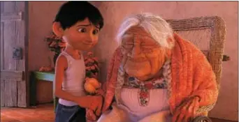  ?? PHOTO COURTESY OF DISNEY-PIXAR ?? Miguel, voiced by Anthony Gonzalez, and Mama Coco, voiced by Ana Ofelia Murguia, are shown in a scene from “Coco.”