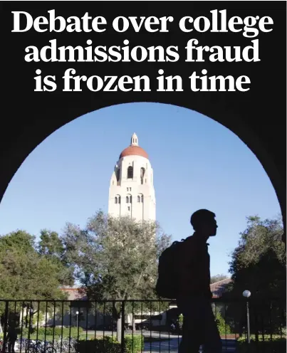  ?? AP FILE ?? A Stanford University student walks in front of Hoover Tower on the Stanford campus in Palo Alto, Calif.