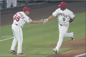  ?? ASHLEY LANDIS - STAFF, AP ?? Los Angeles Angels’ Albert Pujols, right, is greeted by third base coach Brian Butterfiel­d as he runs the bases on a solo home run during the fifth inning of the team’s baseball game against the Texas Rangers on Friday, Sept. 18, 2020, in Anaheim, Calif.