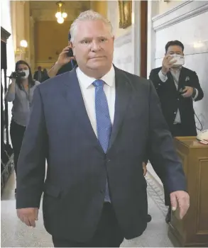  ?? FRANK GUNN / THE CANADIAN PRESS ?? Ontario Premier Doug Ford walks toward Lt.-Gov. Elizabeth Dowdeswell's office
on Tuesday to officially start the provincial election period.