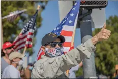  ?? Bobby Block/ The Signal ?? (Above) Kevin Aiken joins demonstrat­ors who lined Valencia Boulevard near the intersecti­on with McBean Parkway Monday afternoon in support of law enforcemen­t officers. (Right) A demonstrat­or identified only as Gary holds a sign during Monday’s rally.