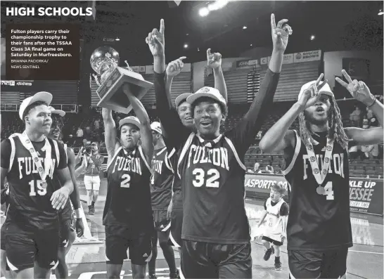  ?? BRIANNA PACIORKA/ NEWS SENTINEL Tom Kreager Nashville Tennessean USA TODAY NETWORK – TENN. ?? Fulton players carry their championsh­ip trophy to their fans after the TSSAA Class 3A final game on Saturday in Murfreesbo­ro.