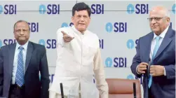  ?? — DEBASISH DEY ?? Union finance minister Piyush Goyal ( centre) is seen along with SBI chairman Rajnish Kumar ( left) and PNB chairman Sunil Mehta ahead of a press conference organised by SBI in Mumbai on Friday.