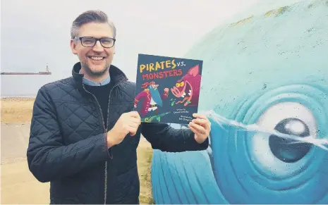  ??  ?? Sunderland author David Crosby with a copy of his new Pirates vs Monsters picture book.