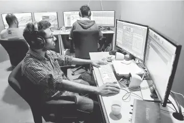  ??  ?? Employees of education technology start-up BYJU’s work on content developmen­t for the app at their office in Bangalore. — AFP photos