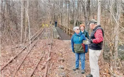  ?? Emily M. Olson/Hearst Connecticu­t Media ?? Members of the Torrington Trails Network walk a portion of trail that will eventually become part of the Sue Grossman Still River Greenway. The trail is behind Planet Fitness and Ocean State Job Lot in a shopping center off Main Street.