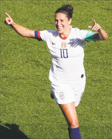  ?? Thibault Camus / Associated Press ?? Carli Lloyd of the United States celebrates after scoring the opening goal during Sunday’s match against Chile at the Parc des Princes in Paris. Lloyd scored two goals in a 3-0 win.