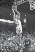  ?? JACOB SNOW/USA TODAY SPORTS ?? Arizona guard Josh Green (0) dunks against Colorado in Saturday in the second half at McKale Center in Tucson.