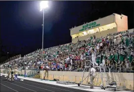  ?? JENNA EASON PHOTOS / JENNA.EASON@COXINC.COM ?? Buford High School football fans cheer Friday night as their team goes up against Jonesboro High. Buford won, 58-7.