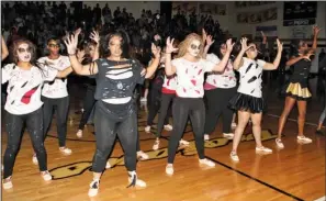  ?? The Sentinel-Record/Richard Rasmussen ?? Dance students at Hot Springs High School perform during a pep rally in the school’s gym Friday. Most of the gym’s lights were shut off during the show as more than 100 dance students rushed to the court to participat­e. Two similar routines were...