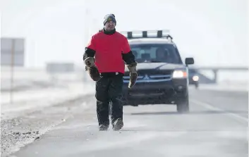  ?? DAVID STOBBE ?? Pernell Ballantyne walks along Highway 11 to Prince Albert to raise awareness about his sister Monica Burns who was murdered three years ago. He plans to reach Prince Albert on Sunday.