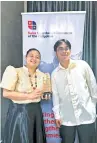  ?? ?? Elyza Marielle Camiguing (left) and Stanley del Rosario (right) of TIP Quezon City accepts a trophy for their team’s win in 2023 Swiss Innovation Prize “Sustainabi­lity” category.