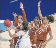  ?? RICARDO B. BRAZZIELL —AUSTIN AMERICAN-STATESMAN VIA AP ?? UCLA’s Kayla Owens (1) is surrounded by Karisma Ortiz, left, Joanne Allen-Taylor (11) and Celeste Taylor (0) of Texas.