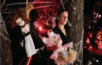  ?? Photos by Brett Coomer/Staff photograph­er ?? Ana Bosch shows off some of her dolls in her elaborate Halloween display Wednesday in The Woodlands. She has collected over 200 dolls since 2018 for her annual display.