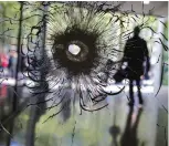  ?? — AP ?? Cracks radiate from a bullet hole in a shop window on the Champs Elysees boulevard in Paris on April 21, 2017.