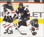  ?? JOHN WOODS / Associated Press ?? Canada’s Laura Stacey (7) falls after a collision with Canada’s Emily Clark (26) and the United States’ Brianna Decker (14) during the first period of a game in Winnipeg, Manitoba. Stacey’s great-grandfathe­r, King Clancy, was a Hall of Fame defenseman...