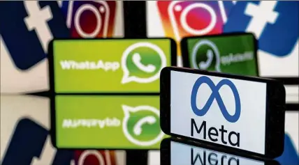  ?? Lionel Bonaventur­e/afp / Getty Images / TNS ?? A smartphone and a computer screen display the logos for Instagram, Facebook, Whatsapp and their parent company Meta. A new subscripti­on service slated for testing would let users pay for a verified account.