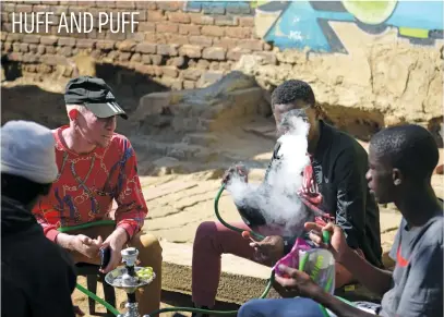  ?? Picture: Tracy Lee Stark ?? Men smoke a hubbly in Kliptown, Soweto, yesterday. Despite a ban, most smokers continue to smoke during the lockdown, with some smoking pipes or rolling their own cigarettes.