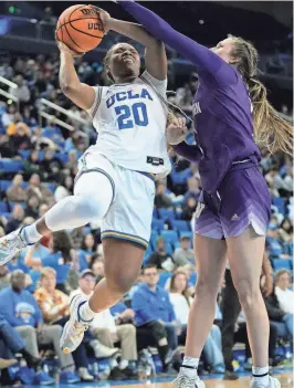  ?? ASHLEY LANDIS/AP ?? UCLA guard Charisma Osborne (20) shoots against Washington guard Hannah Stines on Friday in Los Angeles.