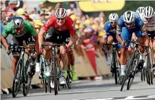  ?? AP ?? Colombia’s Fernando Gaviria, right, crosses the finish line to take out the fourth stage of the Tour de France.