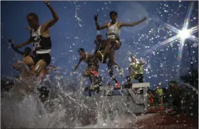  ?? ?? Runners in the men’s 3000m steeplecha­se at Mt San Antonio College, Walnut, California