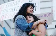  ?? The Associated Press ?? ■ Mitzi Rivas hugs her daughter Maya Iribarren as abortion-rights protesters gather following the Supreme Court’s decision to overturn Roe v. Wade on Thursday at San Francisco City Hall in San Francisco.