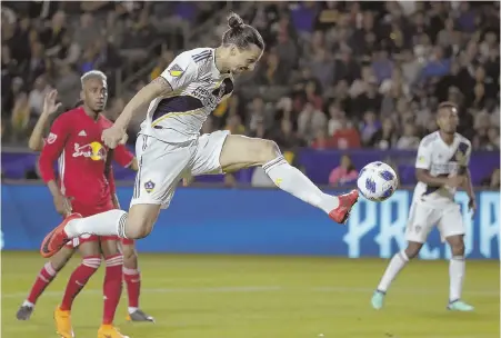  ?? AP FILE PHOTO ?? GALACTIC TALENT: Internatio­nal superstar Zlatan Ibrahimovi­c, shown scoring earlier this season against the New York Red Bulls, leads the LA Galaxy into Gillette Stadium tonight to face the Revolution.