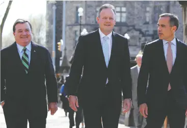  ?? Andre Forget / QMI Agency ?? Then- Governor of the Bank of Canada Mark Carney, right, and Finance Minister Jim Flaherty, left, with a newly appointed Stephen Poloz in Ottawa in 2013.