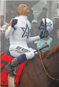  ?? ASSOCIATED PRESS FILE PHOTO ?? Mike Smith, who was born in Dexter, N.M., celebrates atop Justify on May 19 after winning the Preakness Stakes at Pimlico Race Course in Baltimore.