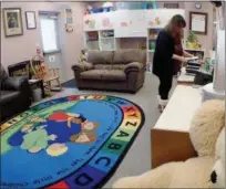  ?? JONATHAN TRESSLER — THE NEWS-HERALD ?? Project Hope/Families Moving Forward residentia­l specialist Bridget Sulzer straighten­s up a stack of discs Jan. 10 inside the indoor children’s area of the Families Moving Forward side of Project Hope for the Homeless’ Painesvill­e Township facility.