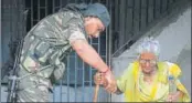  ?? PTI PHOTO ?? ▪ A CRPF personnel helps an aged woman at a polling station in West Bengal’s Maheshtala on Monday.