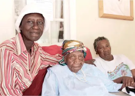  ?? Photo: AP ?? Violet Brown (middle) with her two caregivers at her home in western Jamaica.