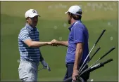  ?? DAVID J. PHILLIP — THE ASSOCIATED PRESS ?? Jordan Spieth and Scottie Scheffler meet at the range during a practice day for the Masters on Monday in Augusta, Ga.